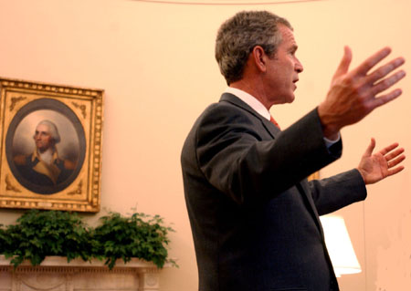 President George W. Bush talks to a group in the Oval Office