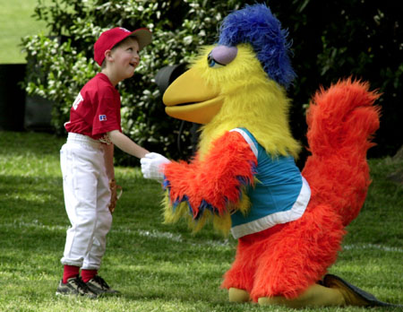 Daniel Allen is congratulated by the San Diego Chicken after catching a fly ball during the first T-Ball game played at the White House on the South Lawn
